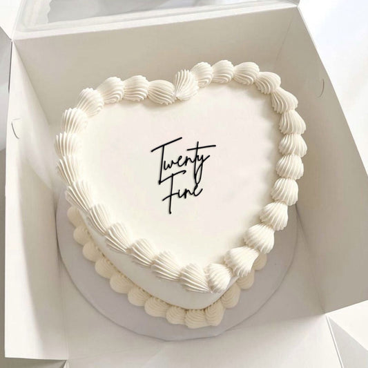 Heart-shaped cake with 'Twenty Fine' text in a white box